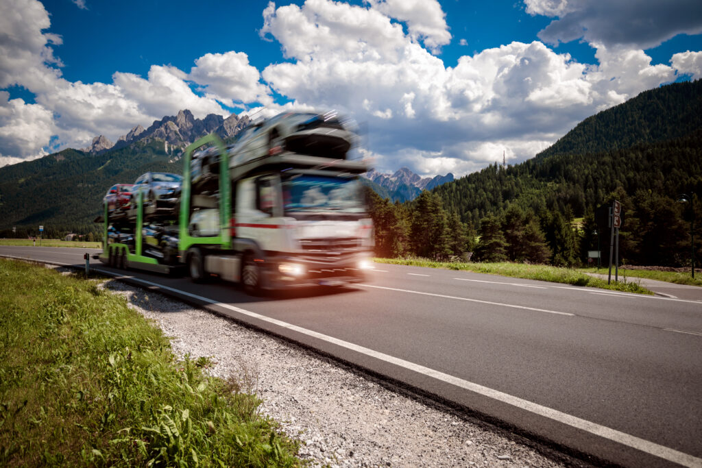 Auto carrier transporting vehicles on a highway